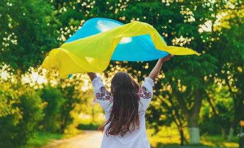 Rear view of girl holding ukraine flag