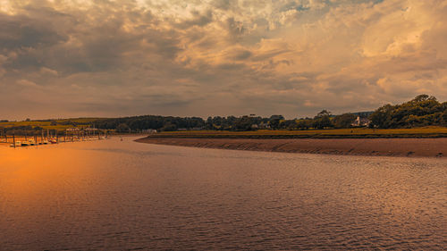 Scenic view of land against sky during sunset