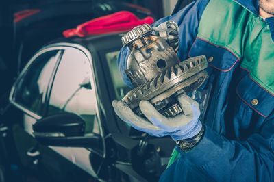 Midsection of mechanic working in workshop