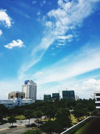 Buildings in city against blue sky