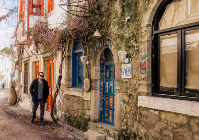 Rear view of man standing against building