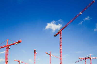 Low angle view of crane against blue sky