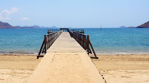 Pier over sea against clear sky