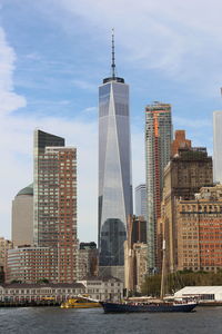 View of skyscrapers against cloudy sky
