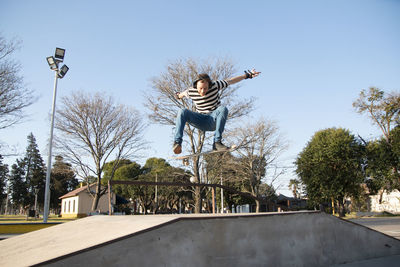 Skateboarder ollie trick in a ramp