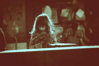 View of girl with eyeglasses looking down