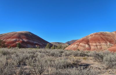 Landscape of two multi colored striped hills in national monument painted hills in oregon