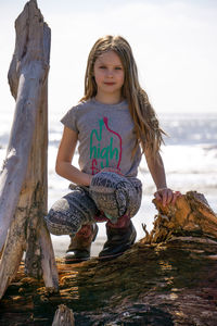 Low angle view of girl on rock