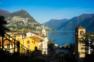 Buildings by mountains against sky