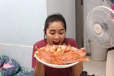 Smiling woman holding prawns