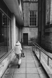 Rear view of man walking on street