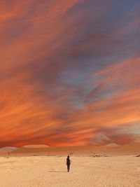 Scenic view of desert against sky during sunset