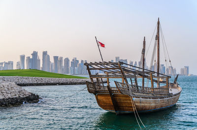 Traditional dhow moored near the museum of islamic art doha, qatar. 