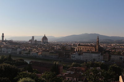 View of buildings in city against clear sky