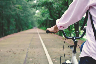 Close-up of person riding bicycle on road