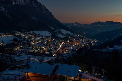 Mountain village icon snow at sunset