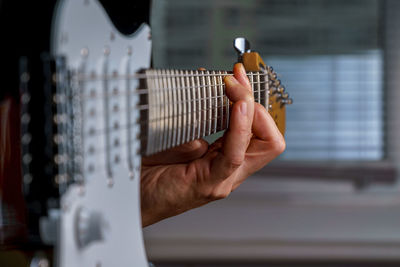 Close-up of hands playing guitar