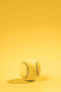 Close-up of ball on yellow background