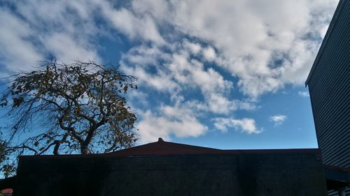 Low angle view of building against cloudy sky