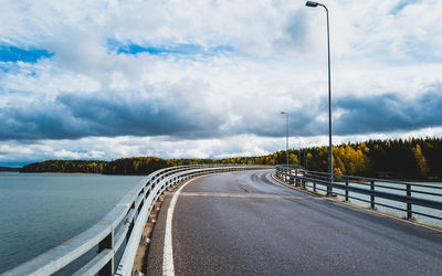 Bridge across sea against cloudy sky during autumn