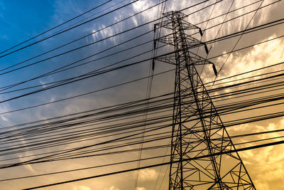 Low angle view of electricity pylon against sky