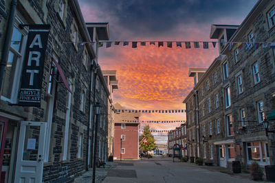 Street amidst buildings in town against sky