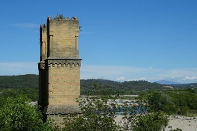 Built structure on landscape against sky