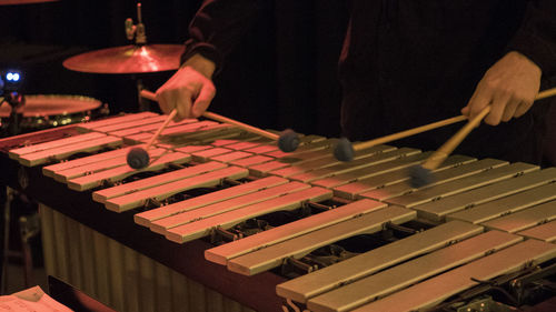 Midsection of man playing xylophone at music concert