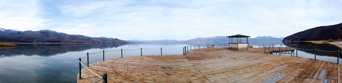 Pier over lake against sky