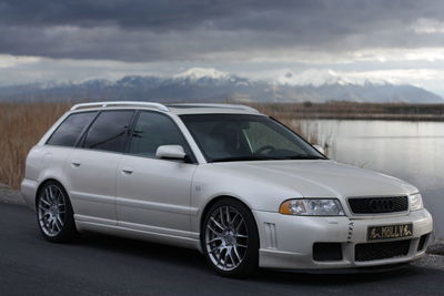 View of car on landscape against cloudy sky