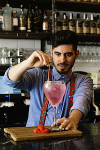 Bartender preparing drink in bar