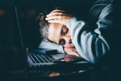 Midsection of woman using laptop