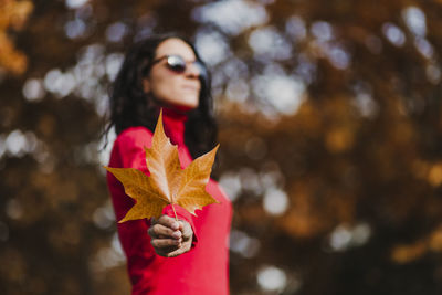 Portrait of young woman standing on plant