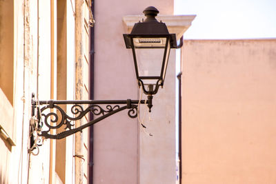 Low angle view of street light against wall