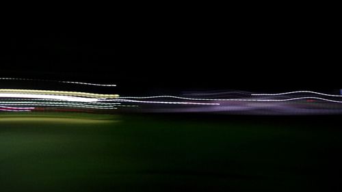 Close-up of light trails over dark background