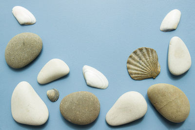 High angle view of pebbles on white surface