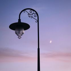 Low angle view of street light against sky