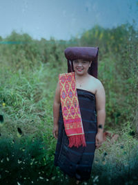 Portrait of teenage girl standing on field