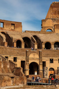 Tourists visiting the interior of the famous colosseum in rome