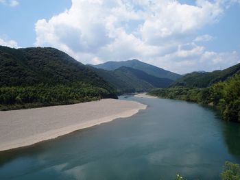 Scenic view of river amidst mountains against sky