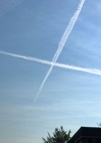 Low angle view of vapor trail in blue sky