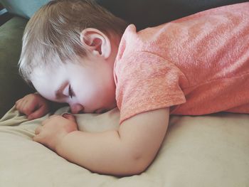 Cute baby girl lying on bed