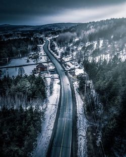 High angle view of road amidst trees against sky