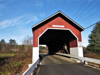 Road by building against sky