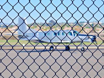 Airplane behind chainlink fence