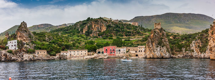 Panoramic shot of buildings and mountains against sky