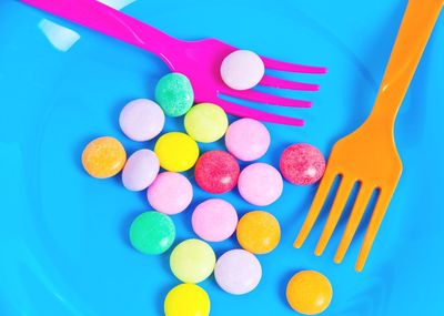 High angle view of colorful candies with fork on plate