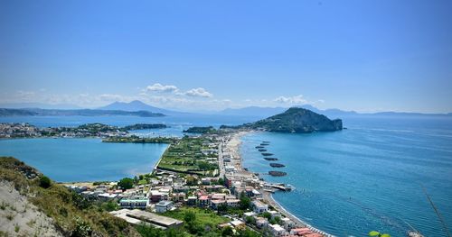 High angle view of sea and city against sky