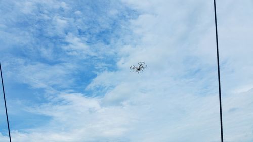 Low angle view of airplane flying against sky