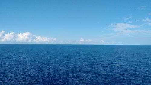 Scenic view of sea against blue sky